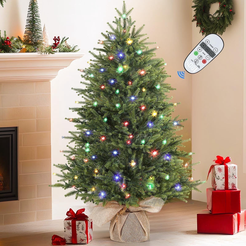 Small artificial Christmas tree by SHareconn with multi-color lights, realistic foliage, and remote control on a tabletop display.